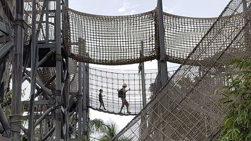 High angle view of people walking under construction building