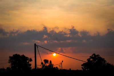 Silhouette trees against sky during sunset