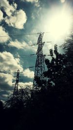 Low angle view of silhouette electricity pylon against sky during sunset