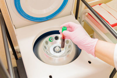 High angle view of person holding plasma in tube at lab