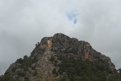 Low angle view of rock formation against sky