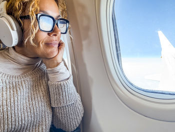 Portrait of woman wearing sunglasses against sky