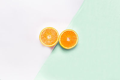 High angle view of orange fruit against white background