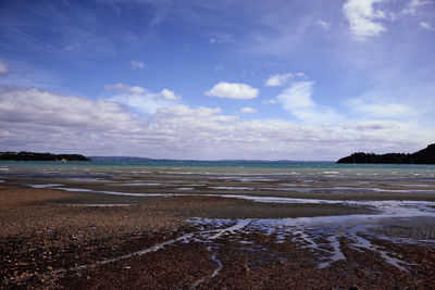 View of beach against cloudy sky