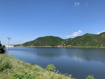 Scenic view of lake against blue sky