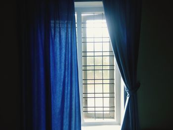 Close-up of curtain against window at home