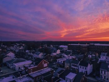 High angle view of illuminated city against sky at sunset