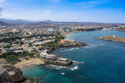 High angle view of sea and buildings against sky