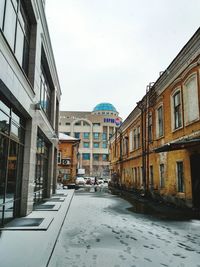 City street during winter against sky