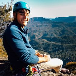 Portrait of man sitting on mountain