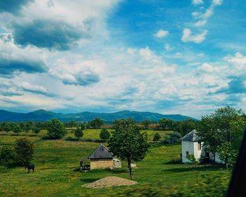 Scenic view of mountains against cloudy sky