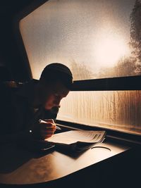 Close-up of man sitting on table