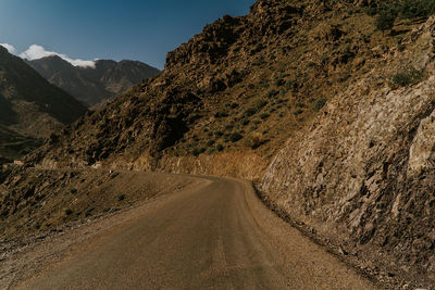 Road amidst mountains against sky