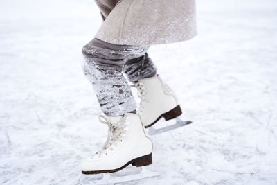 Low section of person standing on snow