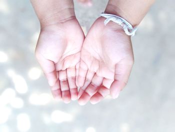 Directly above shot of baby hand over abstract background