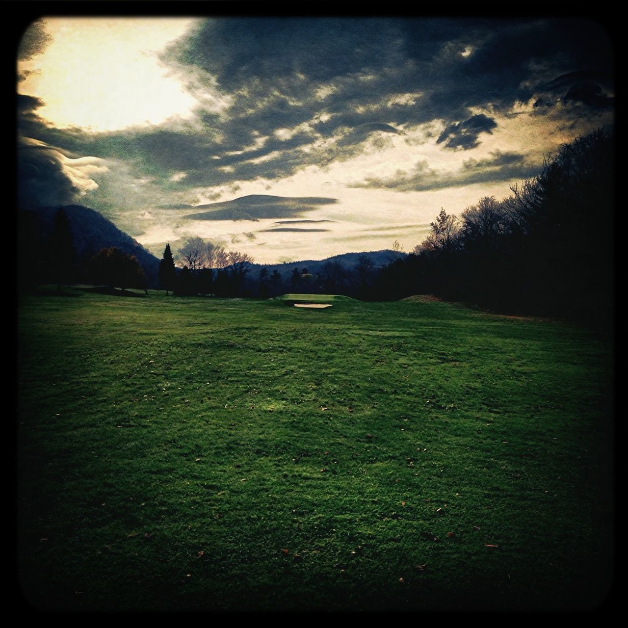 transfer print, sky, cloud - sky, grass, landscape, auto post production filter, field, tranquil scene, tranquility, cloudy, scenics, cloud, grassy, nature, beauty in nature, tree, no people, outdoors, mountain, built structure