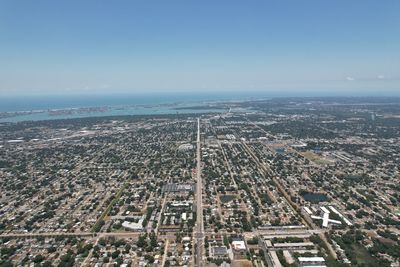 High angle view of buildings by sea against sky