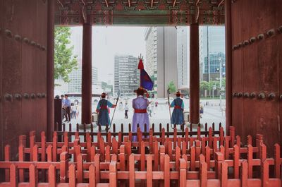 Rear view of people standing in corridor