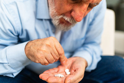 Midsection of man giving medicine