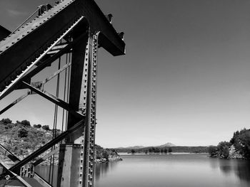 Low angle view of bridge over river against clear sky