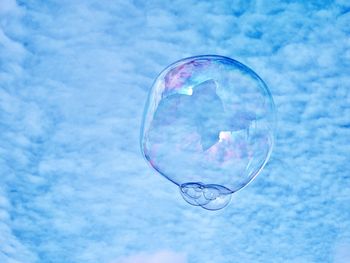 Close-up of bubbles against blue sky