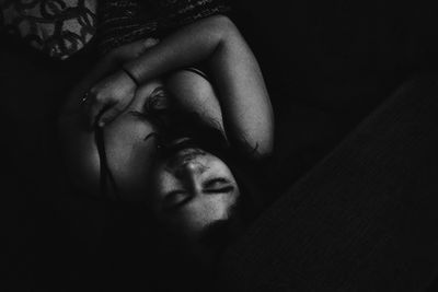 Close-up of woman relaxing on bed at home