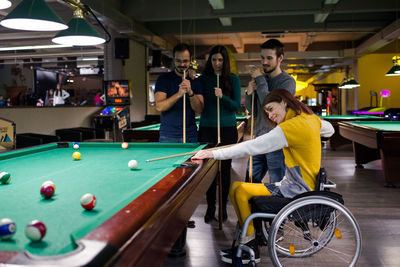 People playing with ball on table