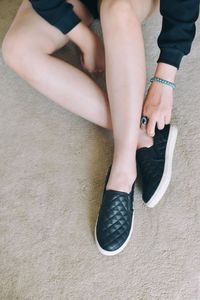 Low section of woman sitting on floor