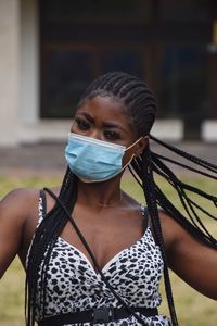 Portrait of young woman wearing mask