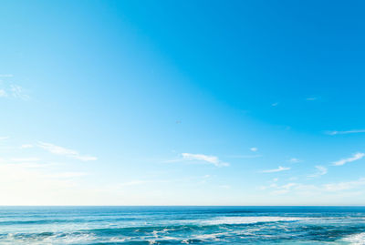 Scenic view of sea against blue sky