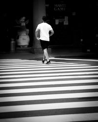 Rear view of woman walking on street