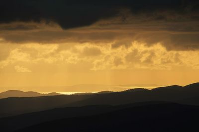 Scenic view of mountains against sky at sunset