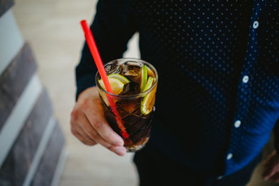 Midsection of woman holding drink