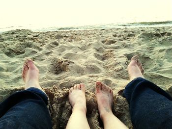 Low section of woman relaxing on beach