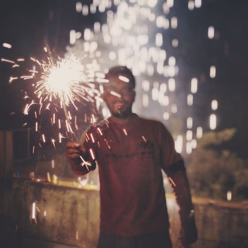 one person, motion, standing, illuminated, night, glowing, firework, real people, front view, men, leisure activity, burning, exploding, holding, arts culture and entertainment, lifestyles, blurred motion, long exposure, sparks, celebration, sparkler, firework display, firework - man made object, outdoors