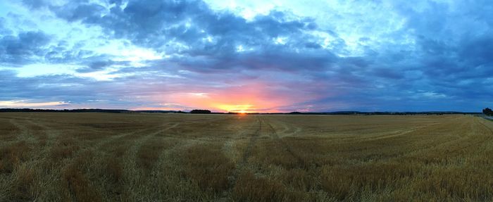 Scenic view of land against sky during sunset