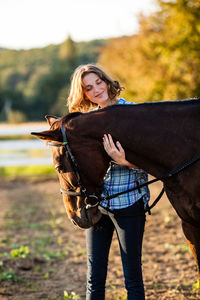 Close-up of woman embracing horse