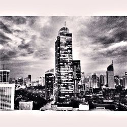 Cityscape against cloudy sky