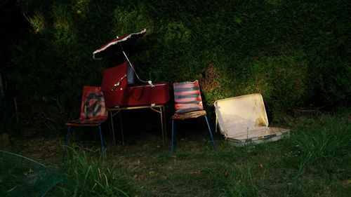 Abandoned chairs and table in garden