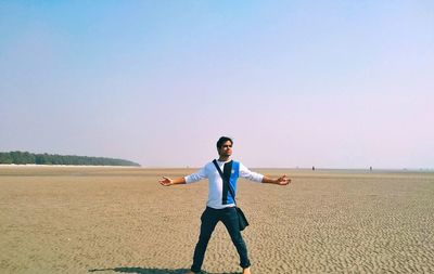 Full length of man standing on field against sky