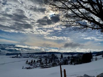 Snow covered landscape against sky