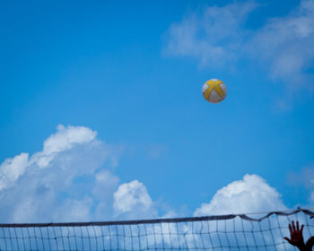 Low angle view of balloons against blue sky