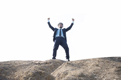 Full length of young man standing on rock