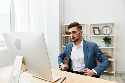 Portrait of businessman using laptop while sitting at home