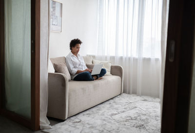 Mixed race female working at home