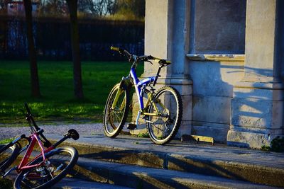 Bicycles parked against wall in city