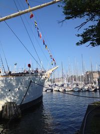 Boats in sea against clear sky