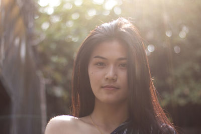 Portrait of young woman standing outdoors