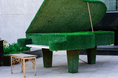 Piano made from green plants in urban landscape
