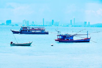 Fishing boat in sea against sky